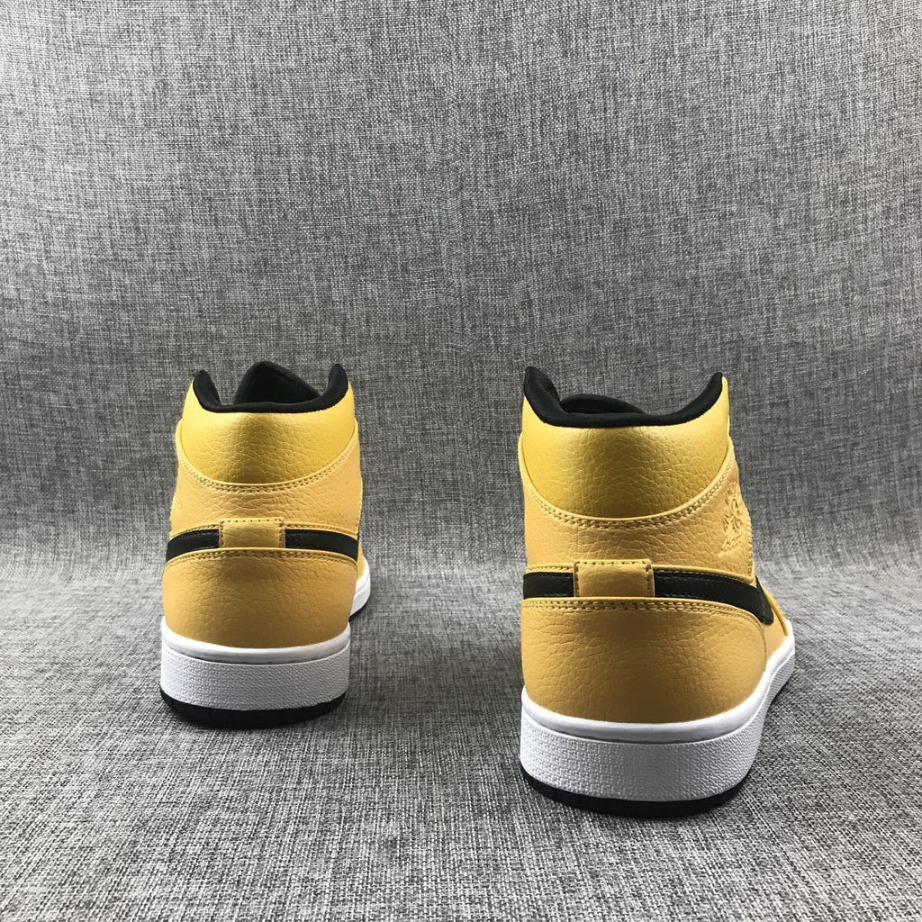 Air Jordan 1 Mid Yellow Ochre Sneakers in Black 554724-700 - product image from the listing.