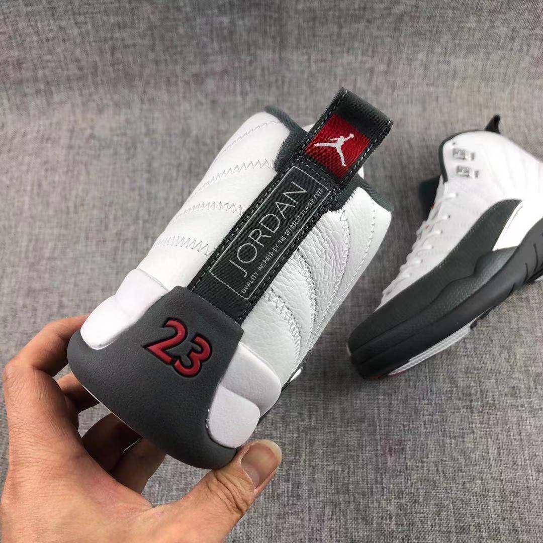 Air Jordan 12 Retro Taxi White Black Sneakers - product image from the listing.