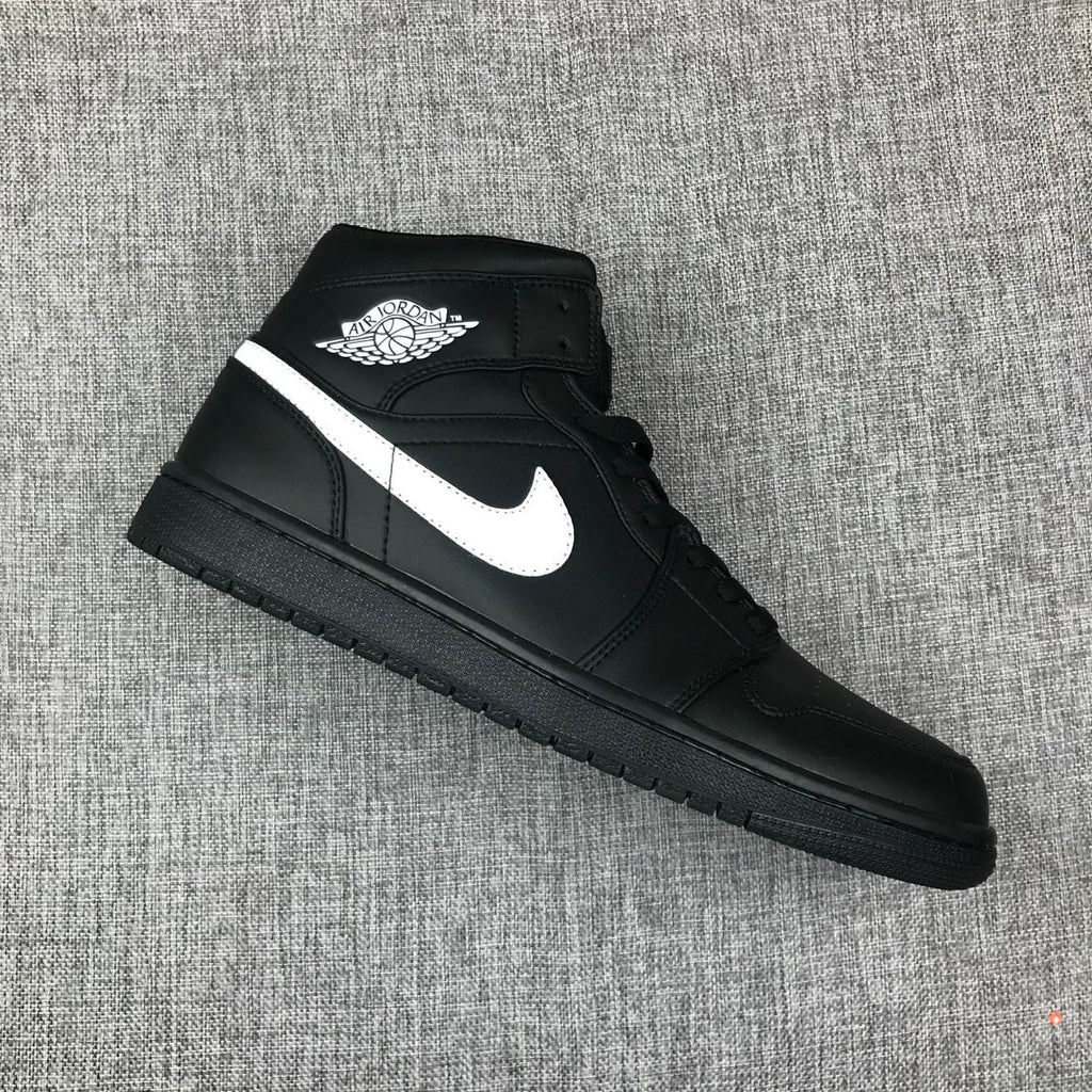 Air Jordan 1 Mid Sneakers in Black White 554724-049 - product image from the listing.