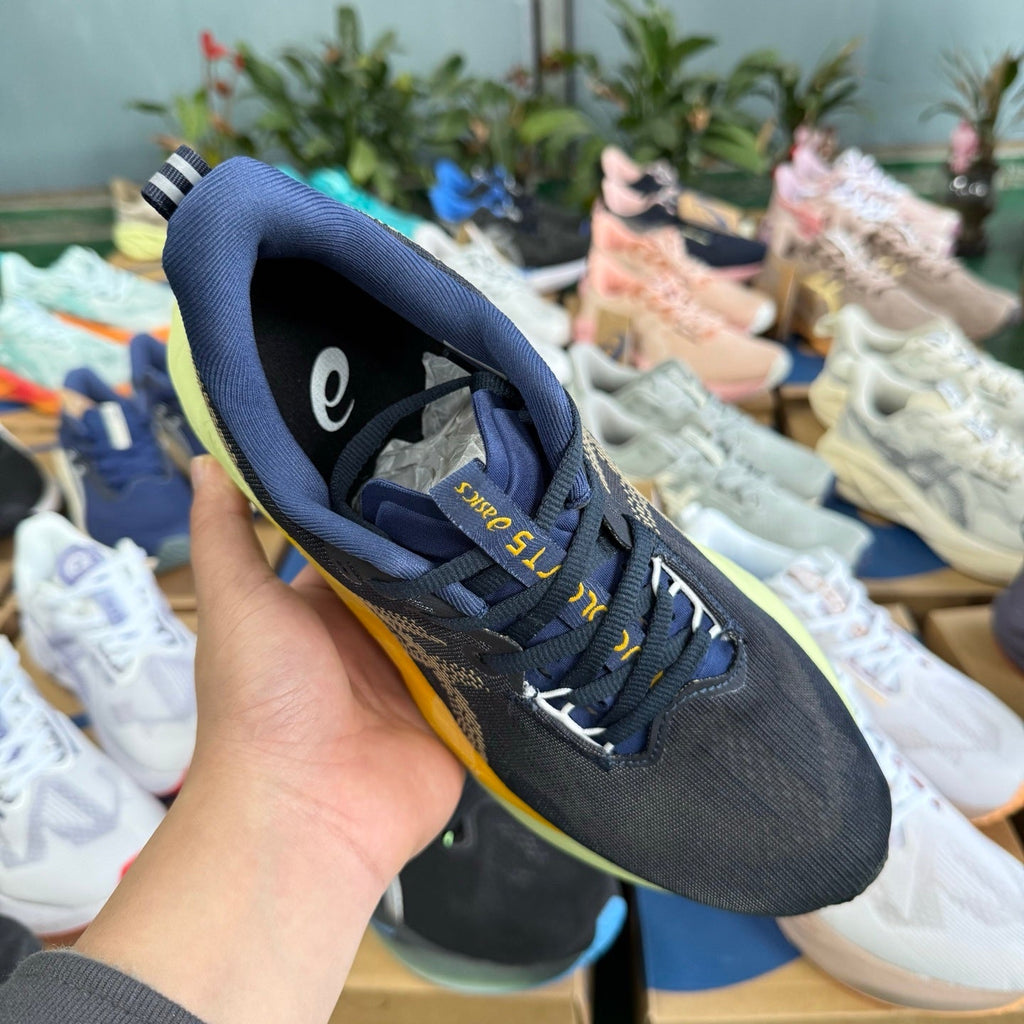 ASICS Novablast 5 LE Running Shoes in Dark Blue Yellow - product image from the listing.