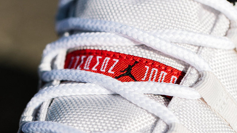 Air Jordan 11 Platinum Tint White High-Top Sneakers - product image from the listing.