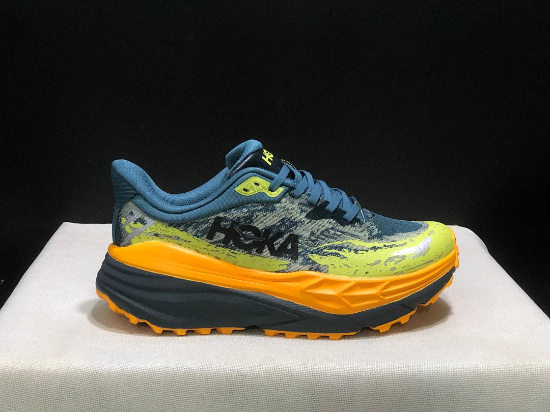HOKA Stinson 7 Trail Running Shoes in Blue Yellow Orange - product image from the listing.