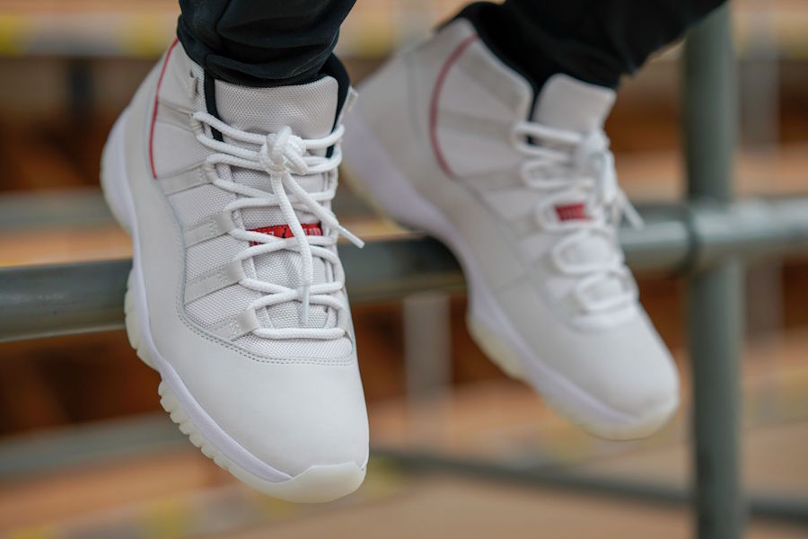 Air Jordan 11 Platinum Tint White High-Top Sneakers - product image from the listing.