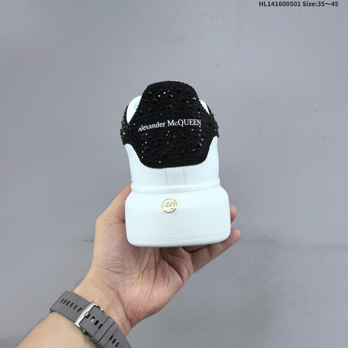 Alexander McQueen Oversized White Low-Cut Sneakers with Black Heel - product image from the listing.