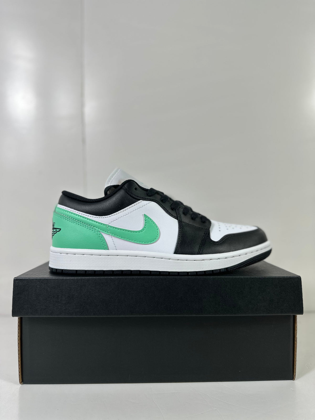 Air Jordan 1 Low White Green Black Sneakers 553558-131 - product image from the listing.