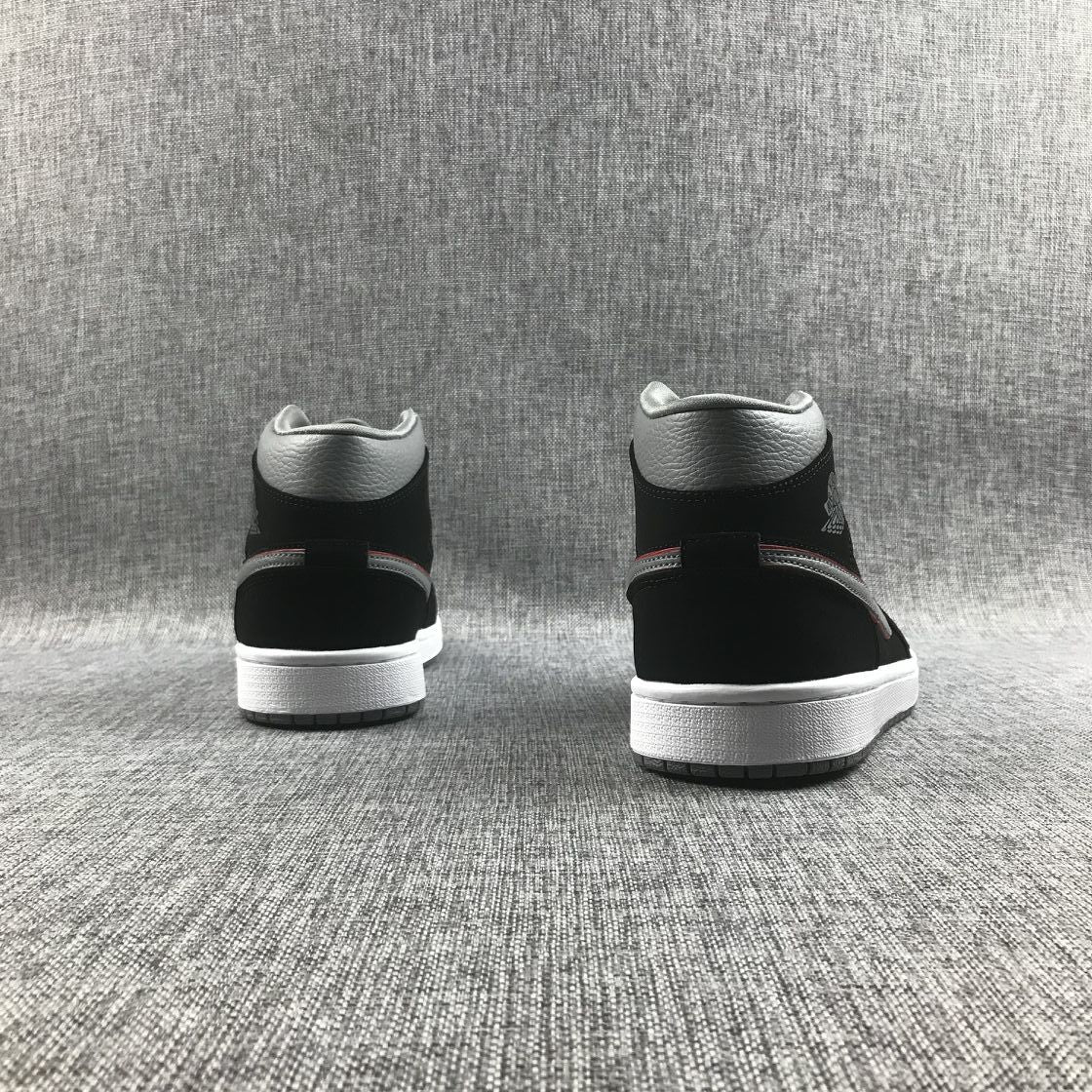 Air Jordan 1 Mid Sneakers in Black Grey Red 554724-060 - product image from the listing.