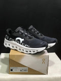 On Cloudmonster Running Sneakers in Black and White - product image from the listing.
