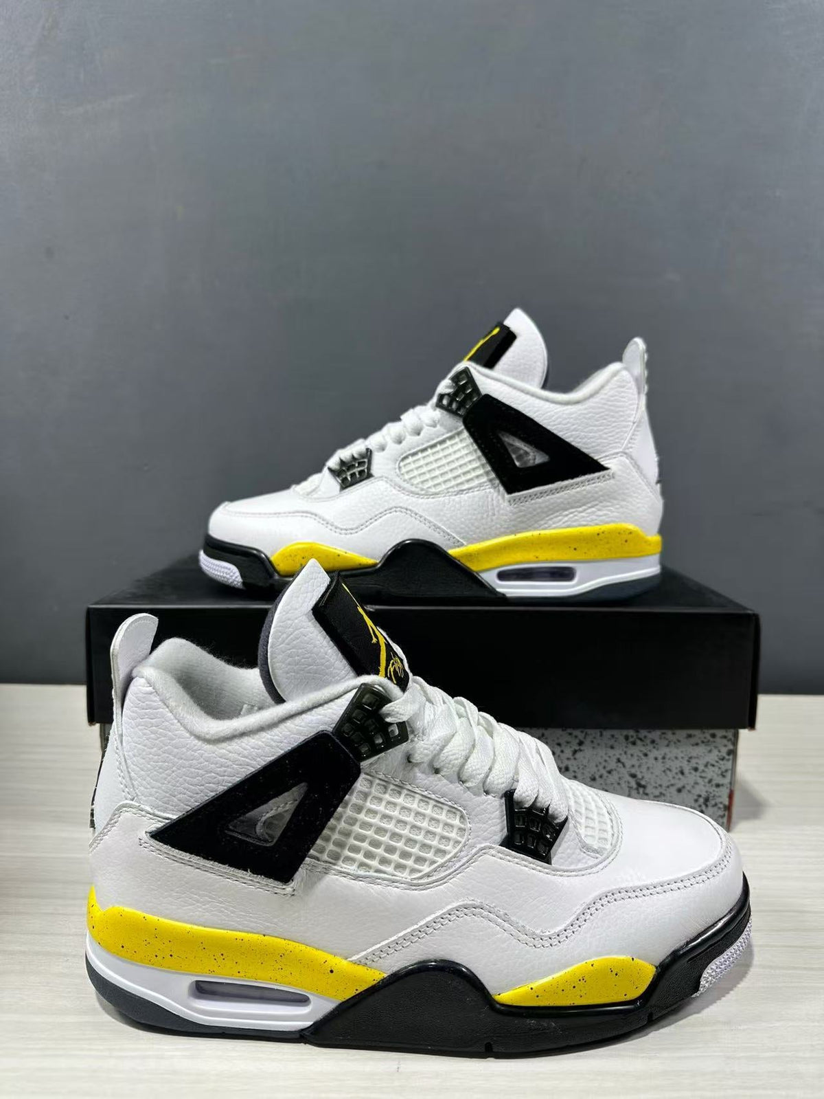 Air Jordan 4 Retro White Yellow Black Sneakers IO2468-102 - product image from the listing.