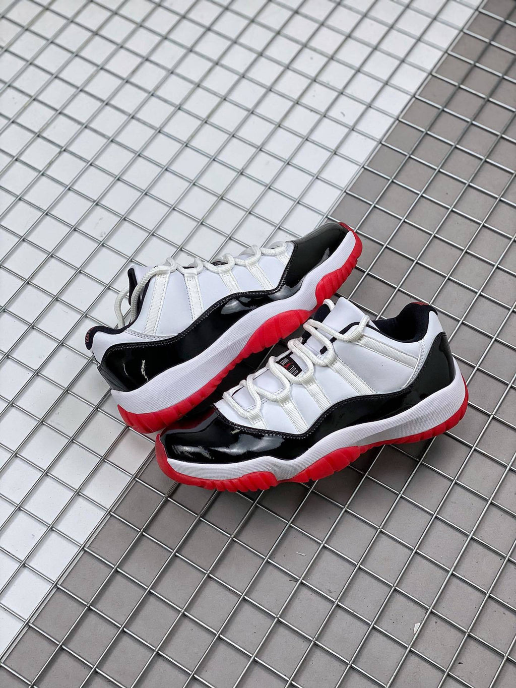 Air Jordan 11 Win Like '82 Sneakers in White Black Red - product image from the listing.