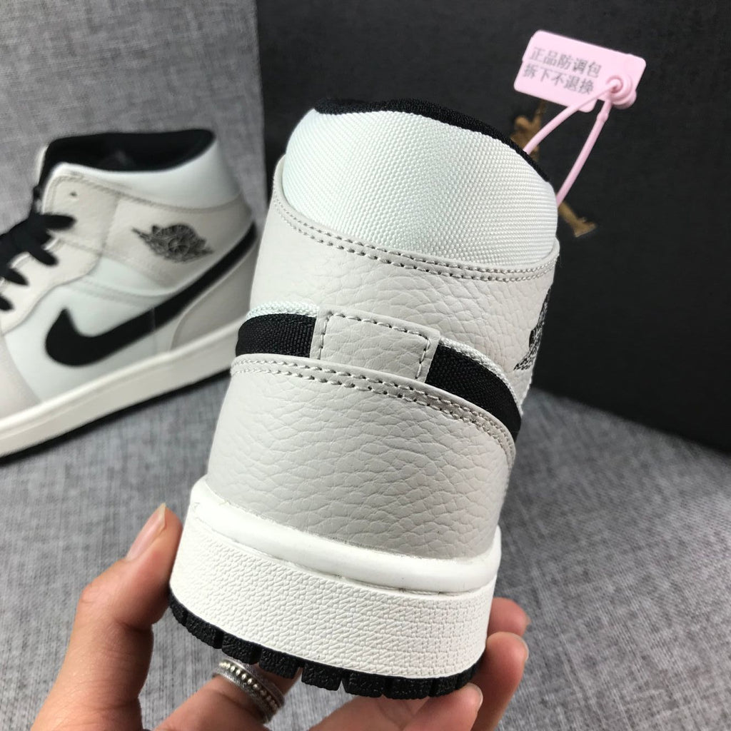 Air Jordan 1 Mid High-Top Sneakers in Grey and Black - product image from the listing.