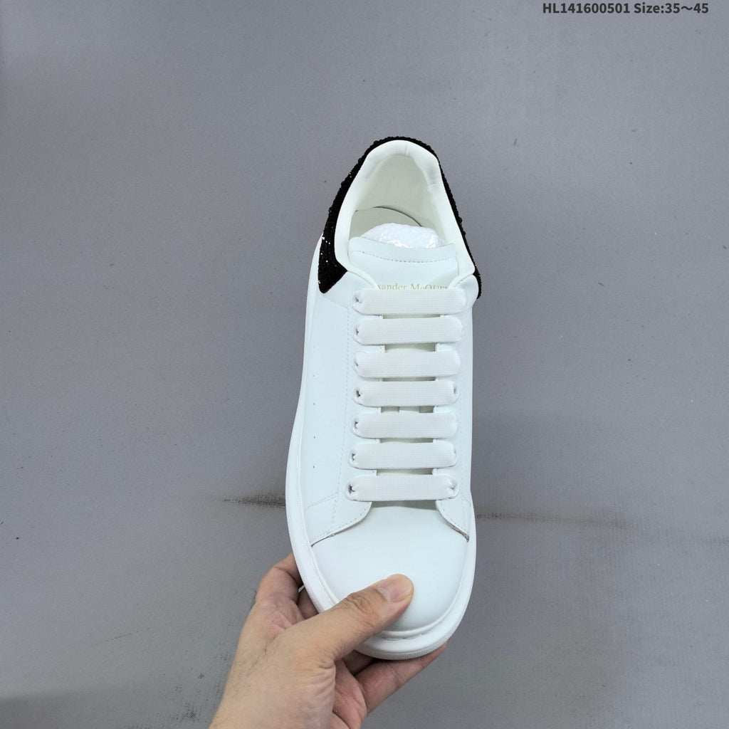 Alexander McQueen Oversized White Low-Cut Sneakers with Black Heel - product image from the listing.