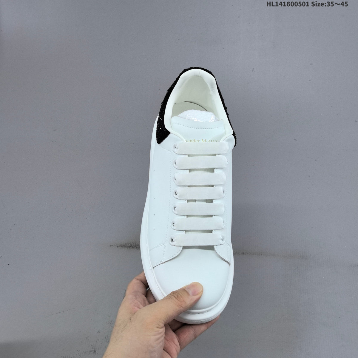 Alexander McQueen Oversized White Low-Cut Sneakers with Black Heel - product image from the listing.