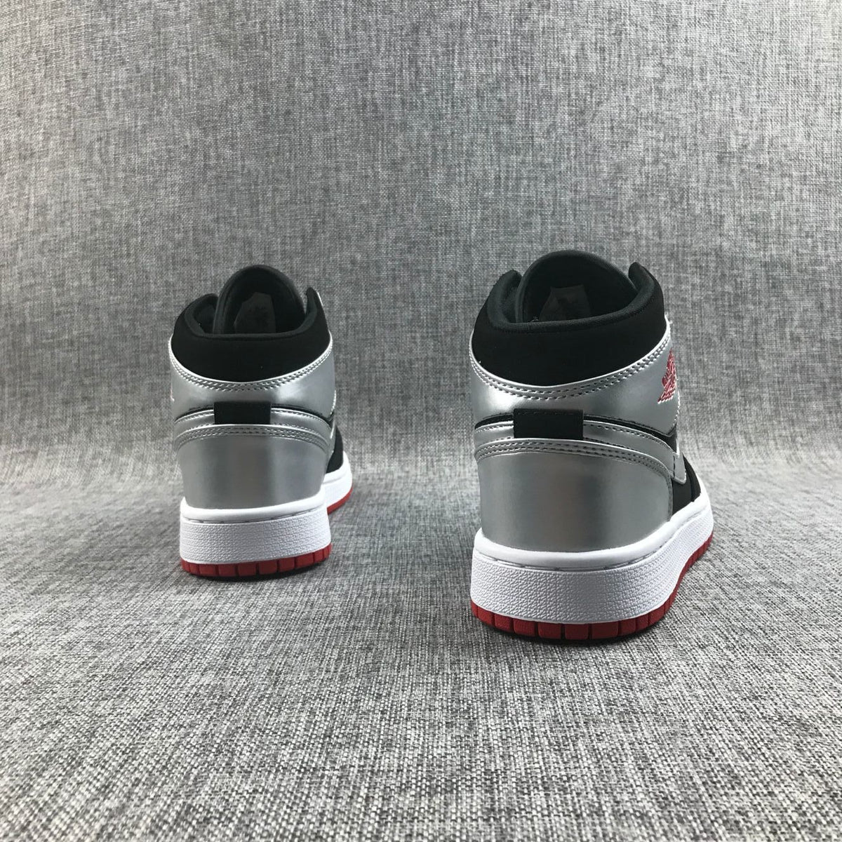 Air Jordan 1 Mid SE GS Sneakers in Black Silver 554725-057 - product image from the listing.