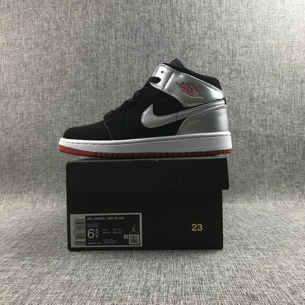 Air Jordan 1 Mid SE GS Sneakers in Black Silver 554725-057 - product image from the listing.