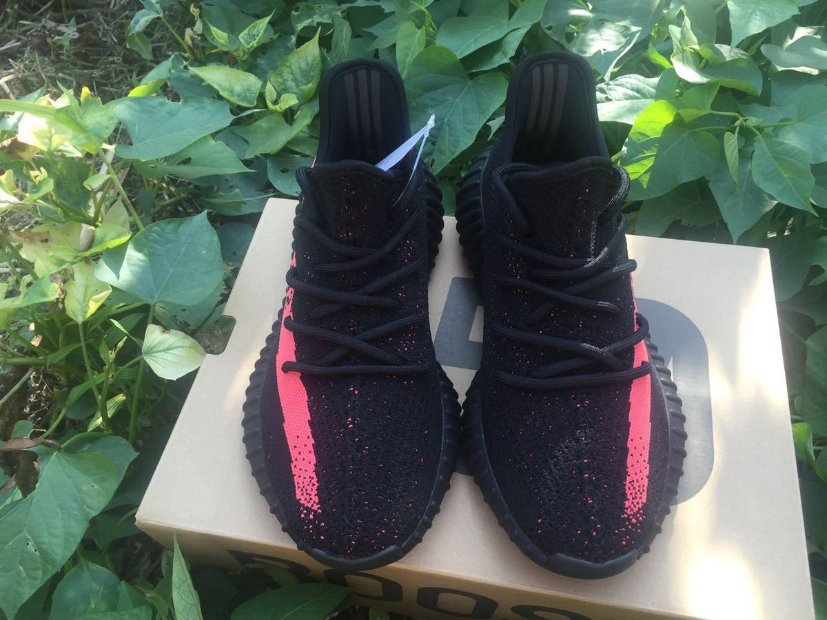 Yeezy Boost 350 V2 Sneakers in Black and Bright Coral - product image from the listing.