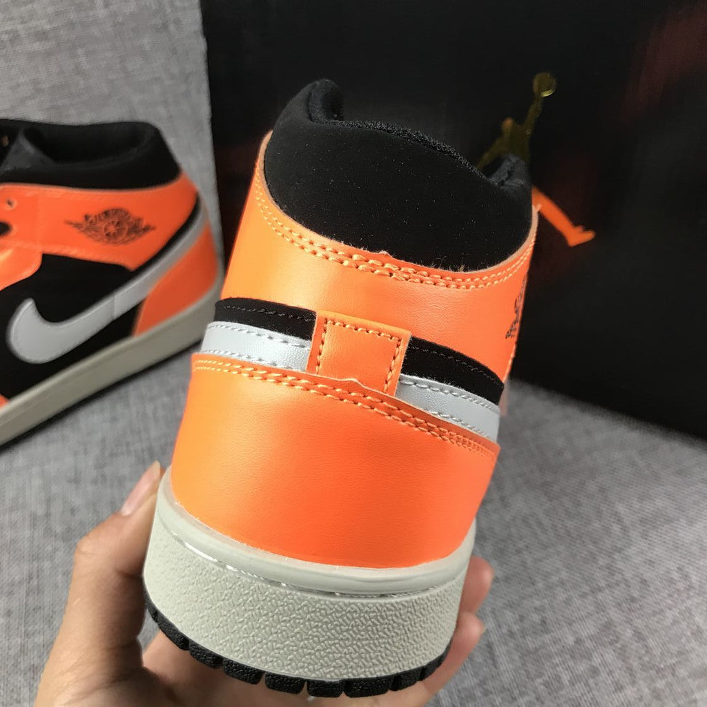 Air Jordan 1 Mid Sneakers in Black Orange 554724-062 - product image from the listing.