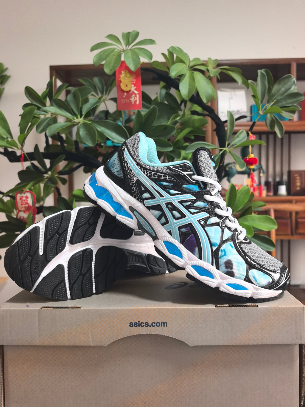 ASICS GEL-NIMBUS 16 Sneakers in Black, in Gray and Ice Blue - product image from the listing.