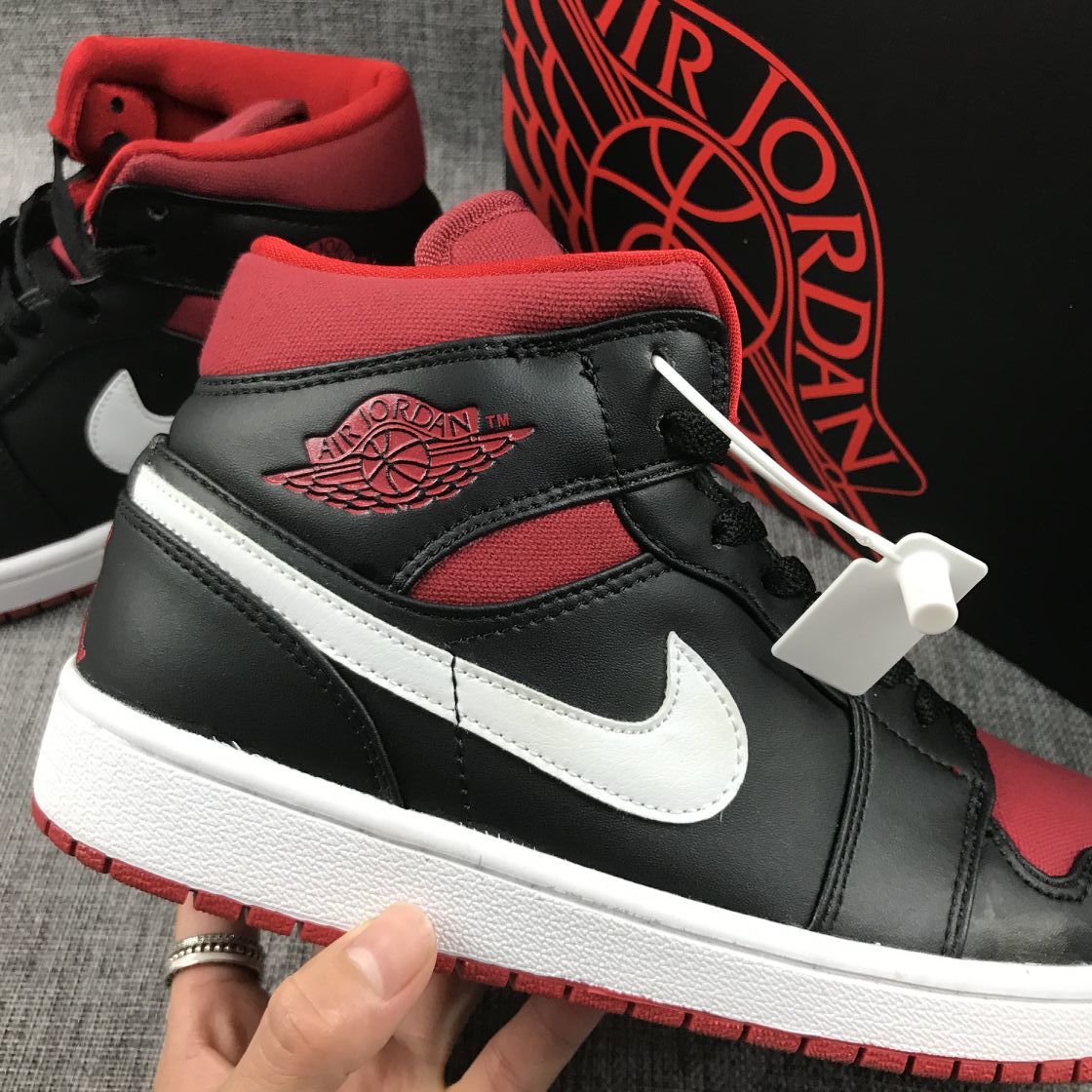Black Red Canvas-Style Sneakers - Jordan 1 Mid 554724-020 - product image from the listing.
