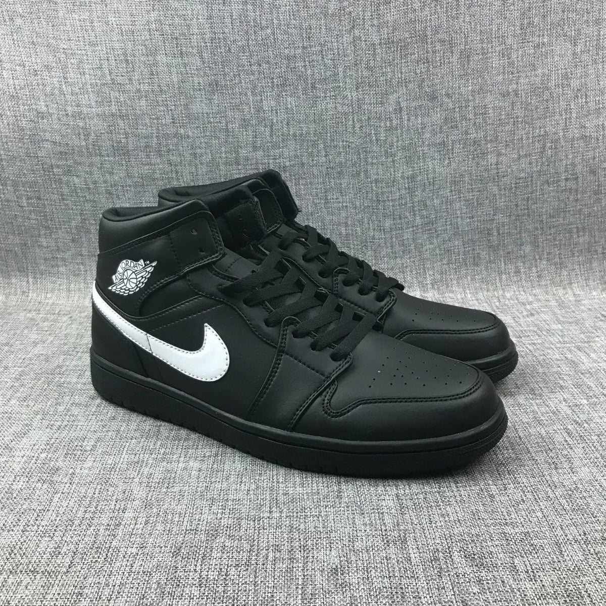 Air Jordan 1 Mid Sneakers in Black White 554724-049 - product image from the listing.