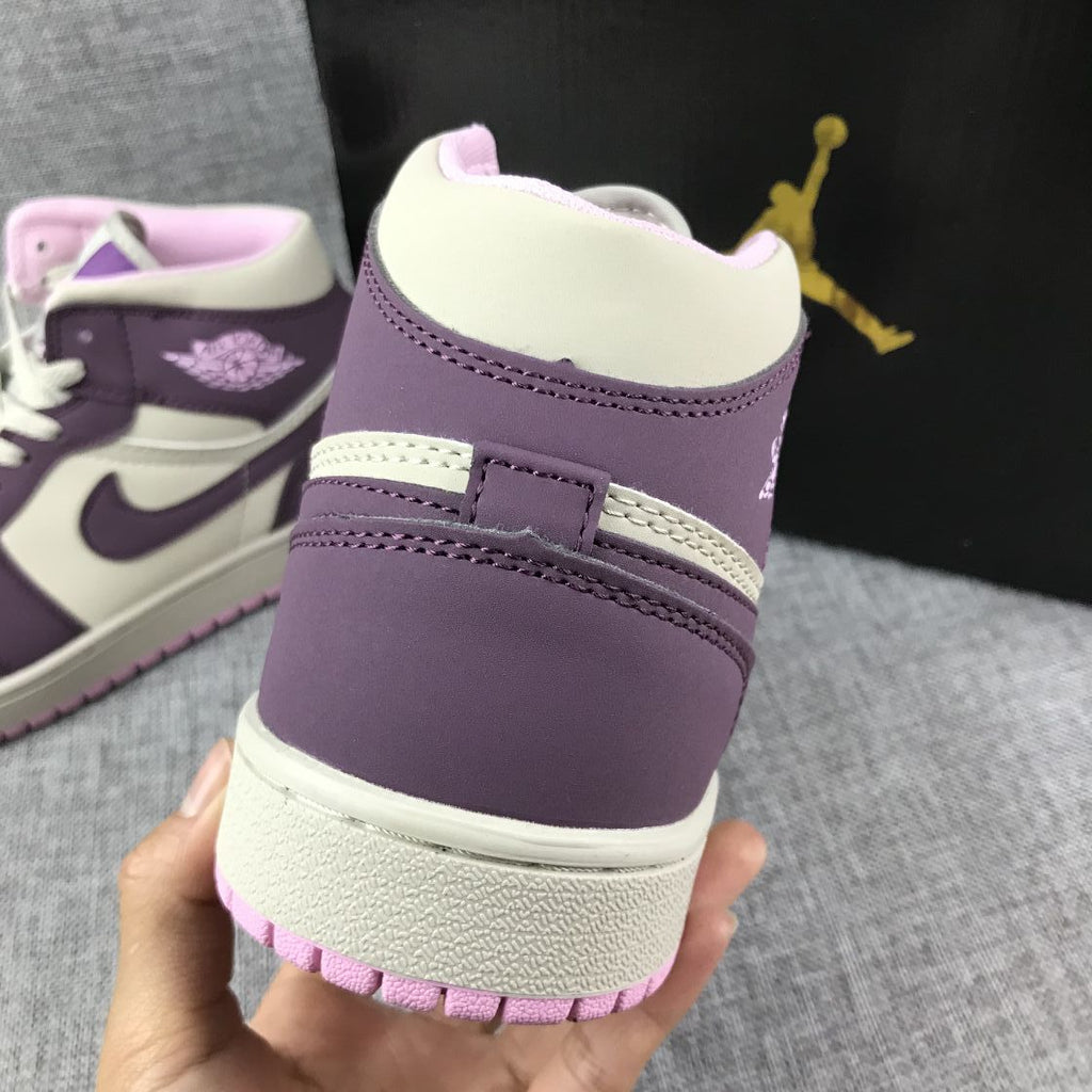 Air Jordan 1 Mid Sneakers in Pink Purple 555112-500 - product image from the listing.