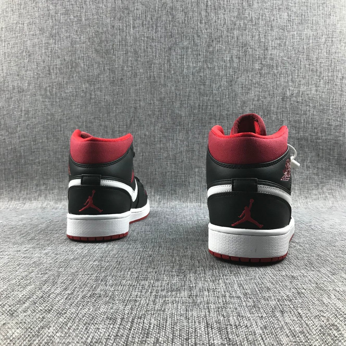 Black Red Canvas-Style Sneakers - Jordan 1 Mid 554724-020 - product image from the listing.