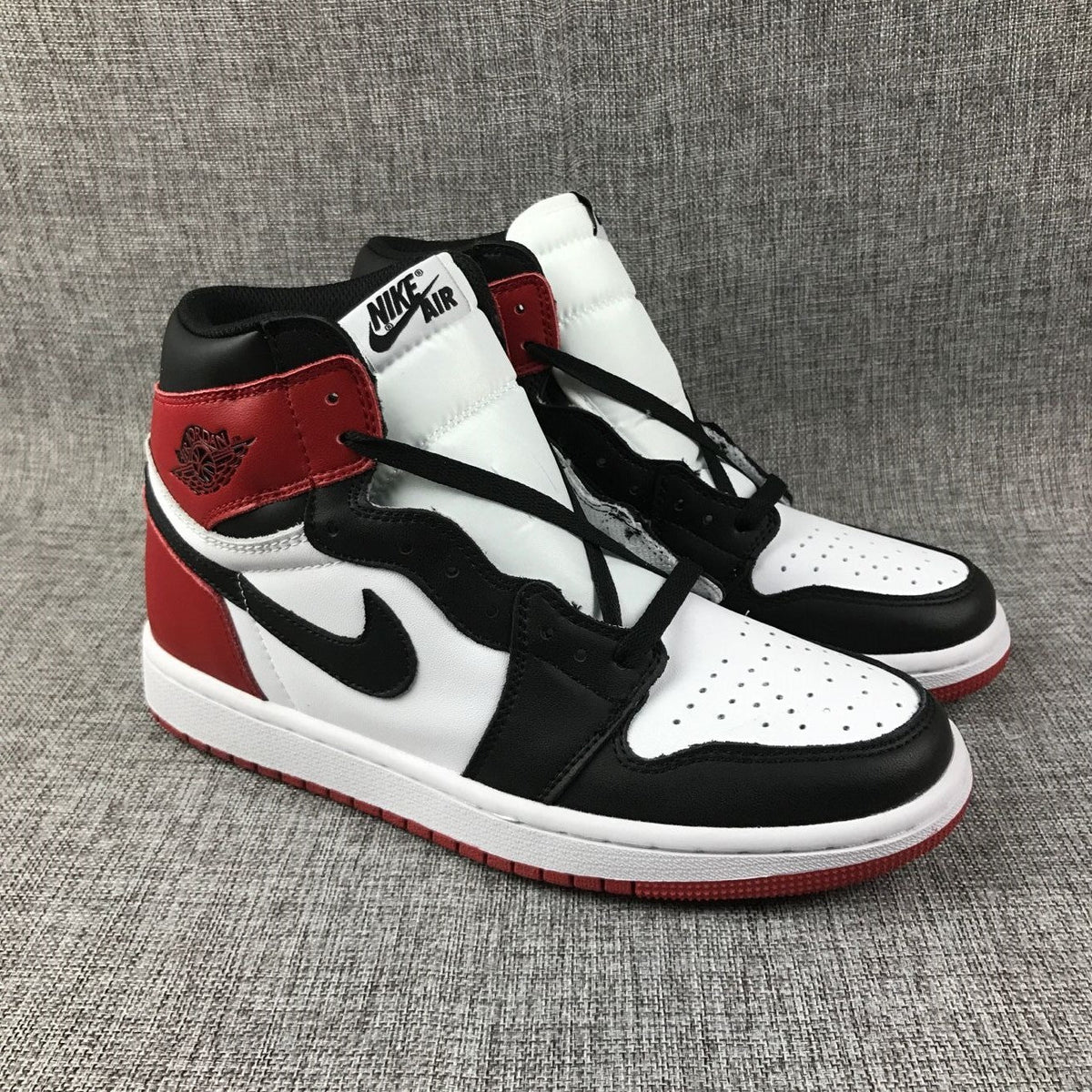 Black Toe Sneakers - Air Jordan 1 High 555088-184 - product image from the listing.