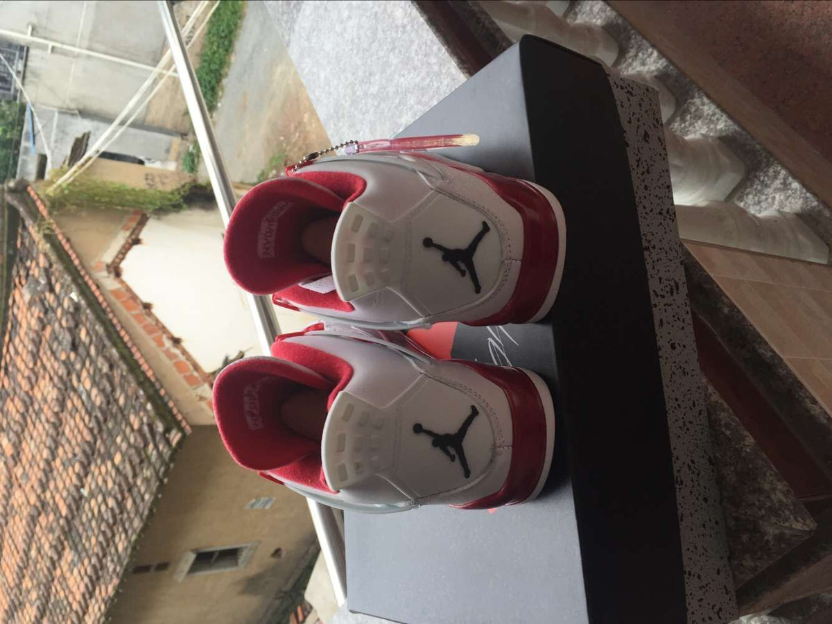 Jordan 4 Retro High-Top Sneakers in White and Red - product image from the listing.