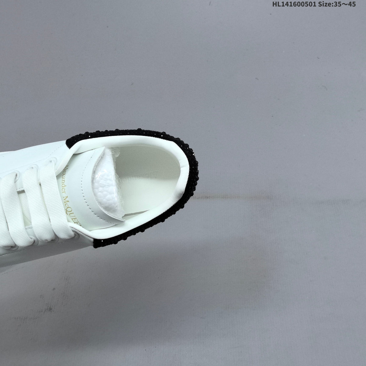 Alexander McQueen Oversized White Low-Cut Sneakers with Black Heel - product image from the listing.