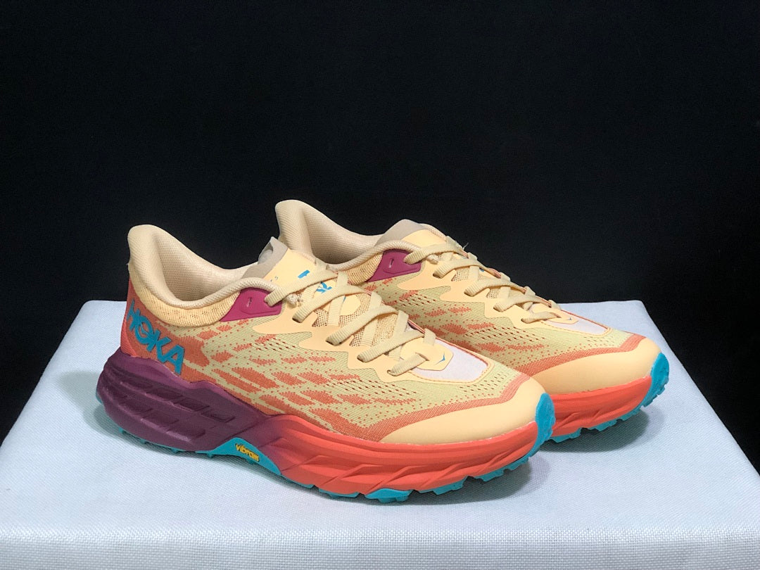 Yellow and Coral HOKA Speedgoat 5 Trail Running Shoes - product image from the listing.