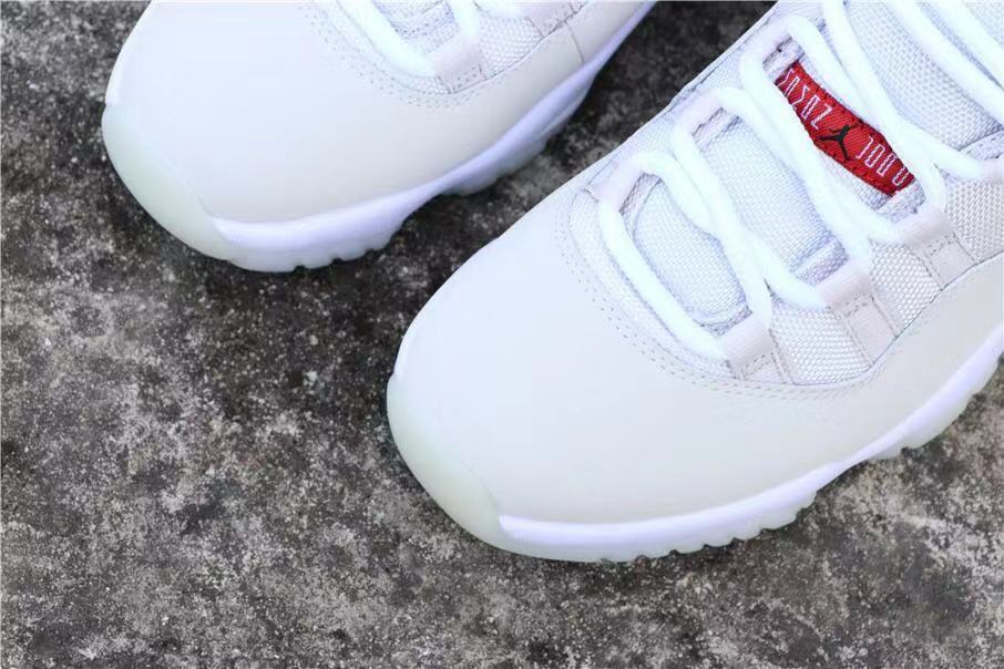 Air Jordan 11 Platinum Tint White High-Top Sneakers - product image from the listing.
