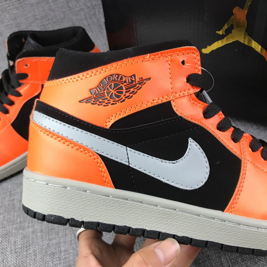 Air Jordan 1 Mid Sneakers in Black Orange 554724-062 - product image from the listing.