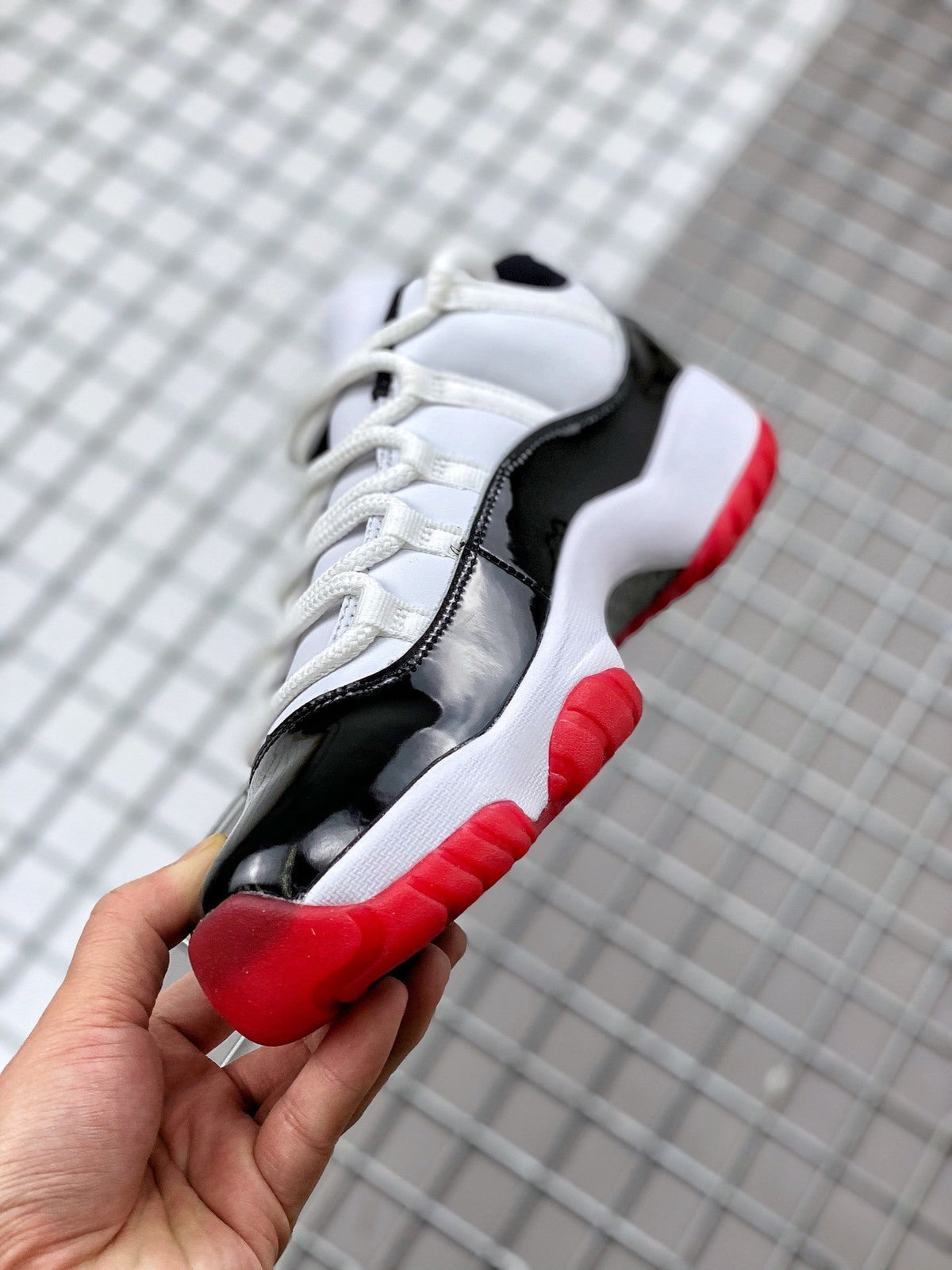 Air Jordan 11 Win Like '82 Sneakers in White Black Red - product image from the listing.