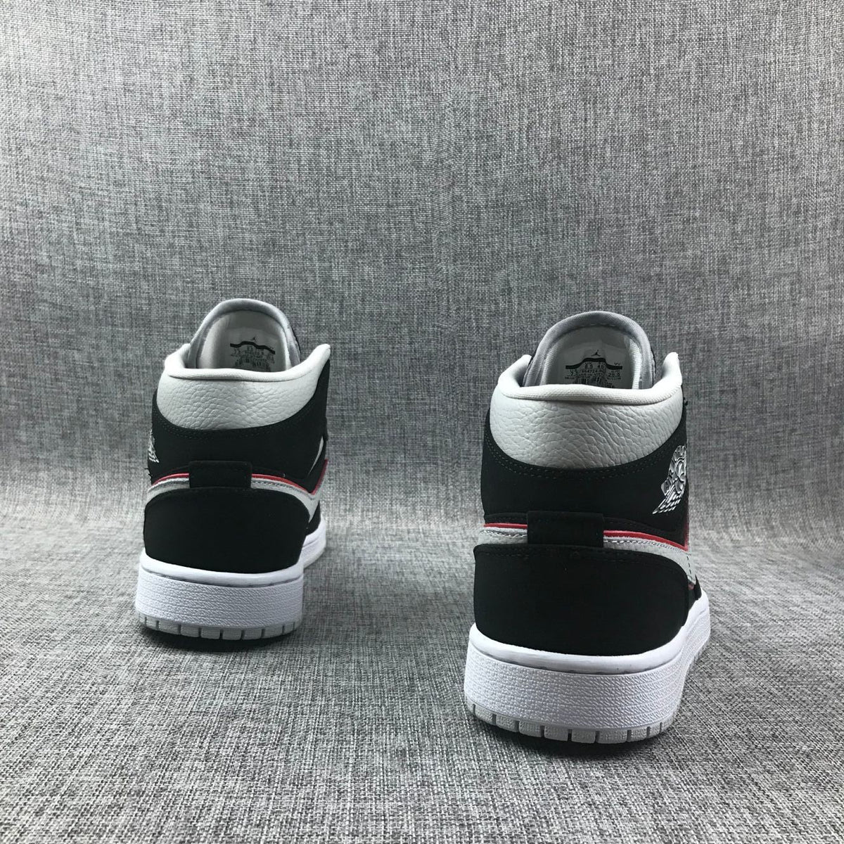 Air Jordan 1 Mid Black, Sneakers in White & Red 554724-060 - product image from the listing.