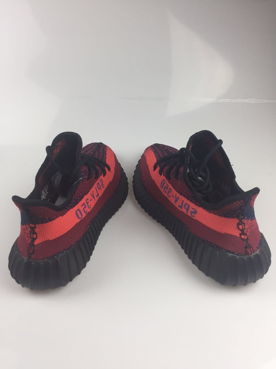Adidas Yeezy Boost 350 V2 Sneakers in Black and Burgundy - product image from the listing.