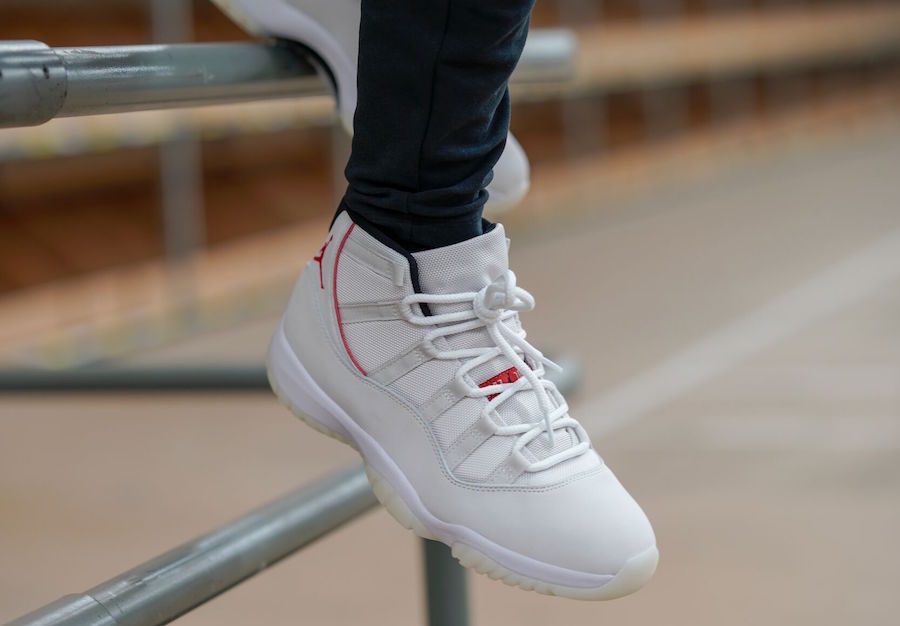 Air Jordan 11 Platinum Tint White High-Top Sneakers - product image from the listing.
