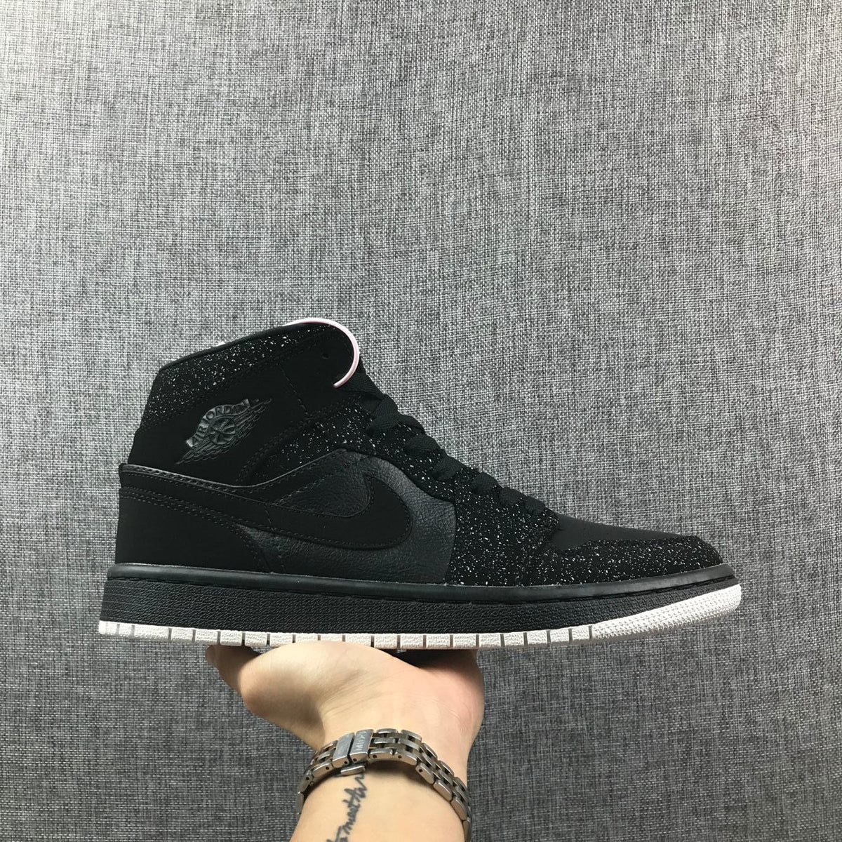 Air Jordan 1 Mid Black and White Sneakers 554724-001 - product image from the listing.