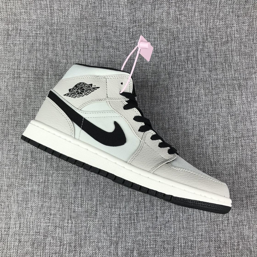 Air Jordan 1 Mid High-Top Sneakers in Grey and Black - product image from the listing.