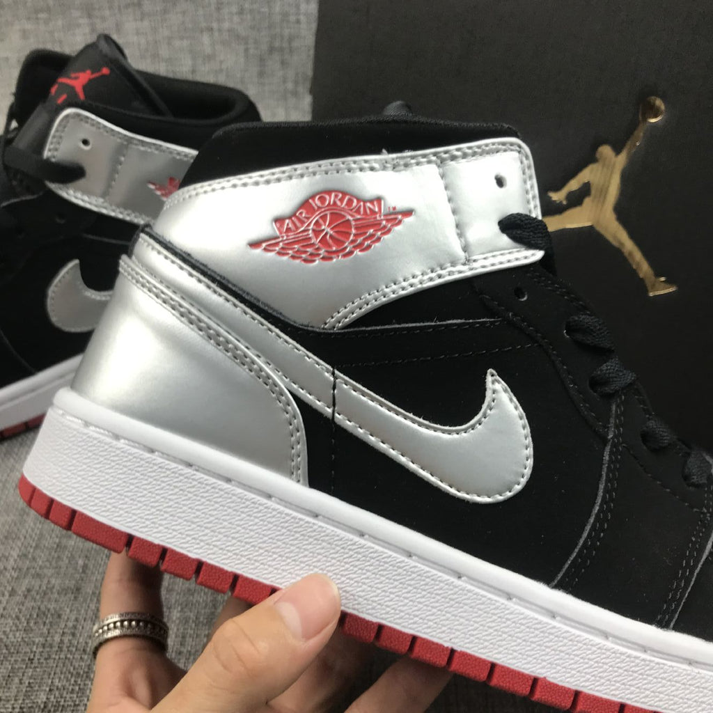 Air Jordan 1 Mid SE GS Sneakers in Black Silver 554725-057 - product image from the listing.