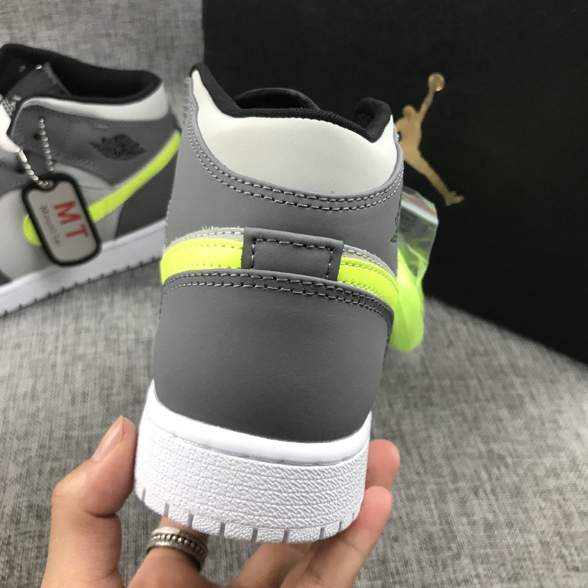 Air Jordan 1 Mid Sneakers in Grey Volt 554724-072 - product image from the listing.