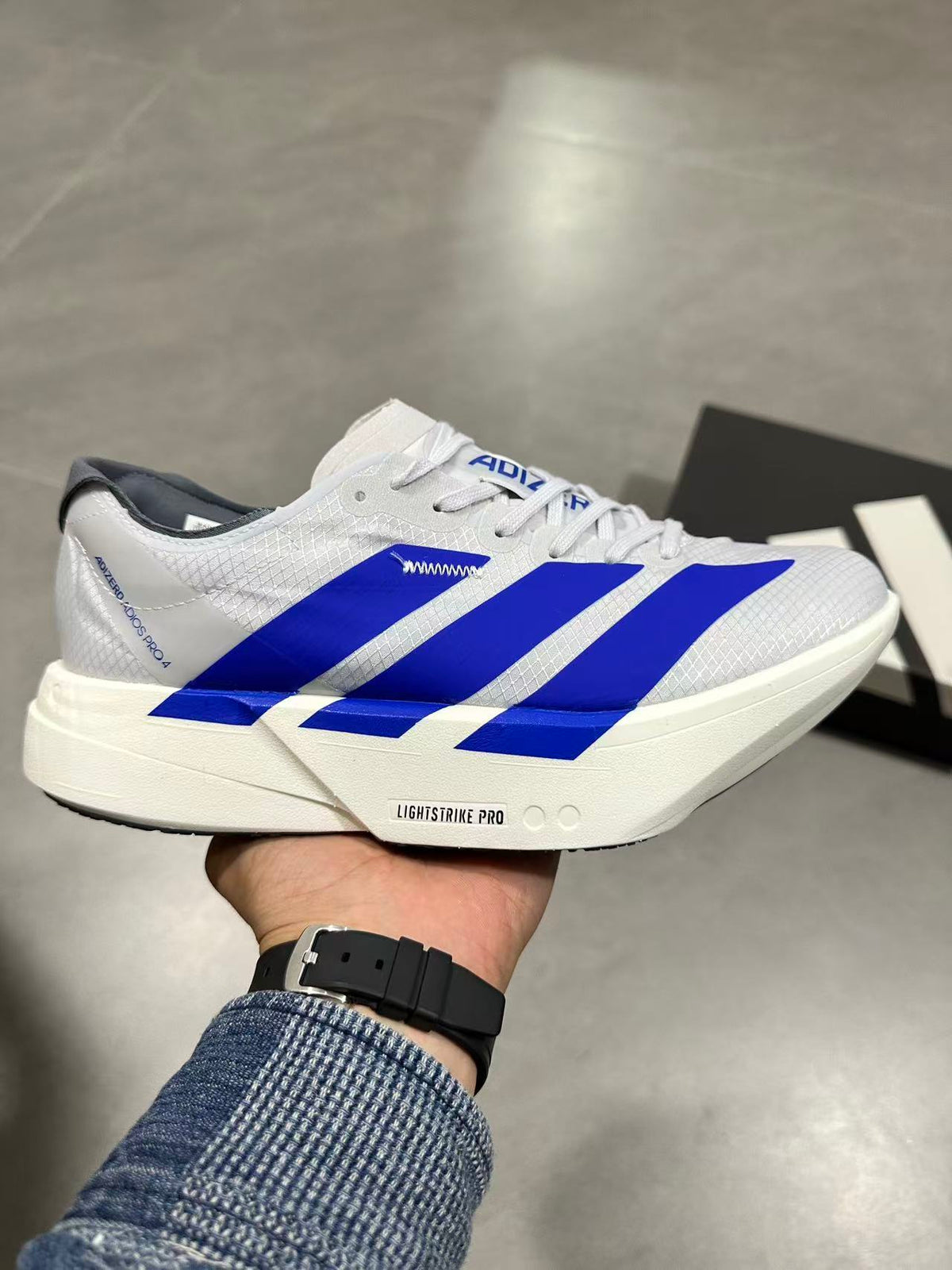 adidas Lightstrike Pro Running Shoes in White Blue - product image from the listing.