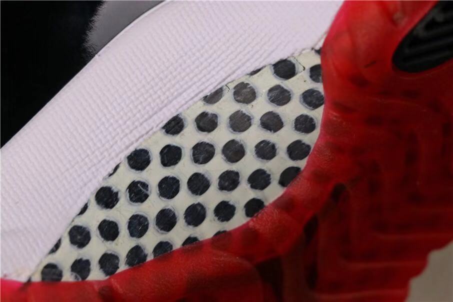 Air Jordan 11 Retro Bred High-Top Sneakers in Black and Red - product image from the listing.