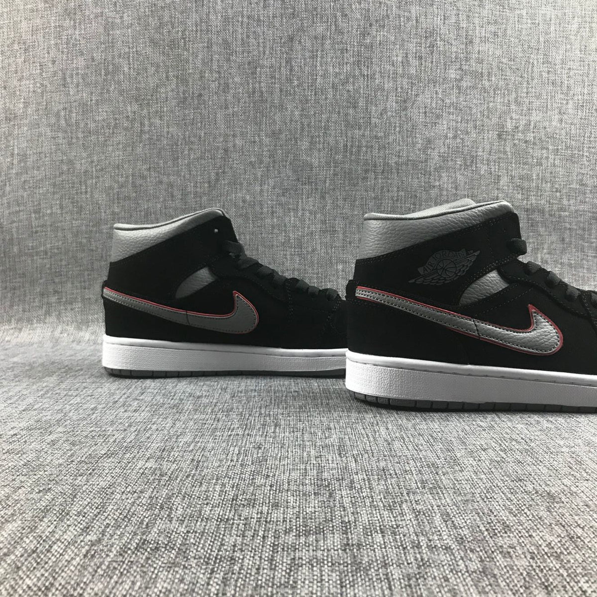 Air Jordan 1 Mid Sneakers in Black Grey Red 554724-060 - product image from the listing.