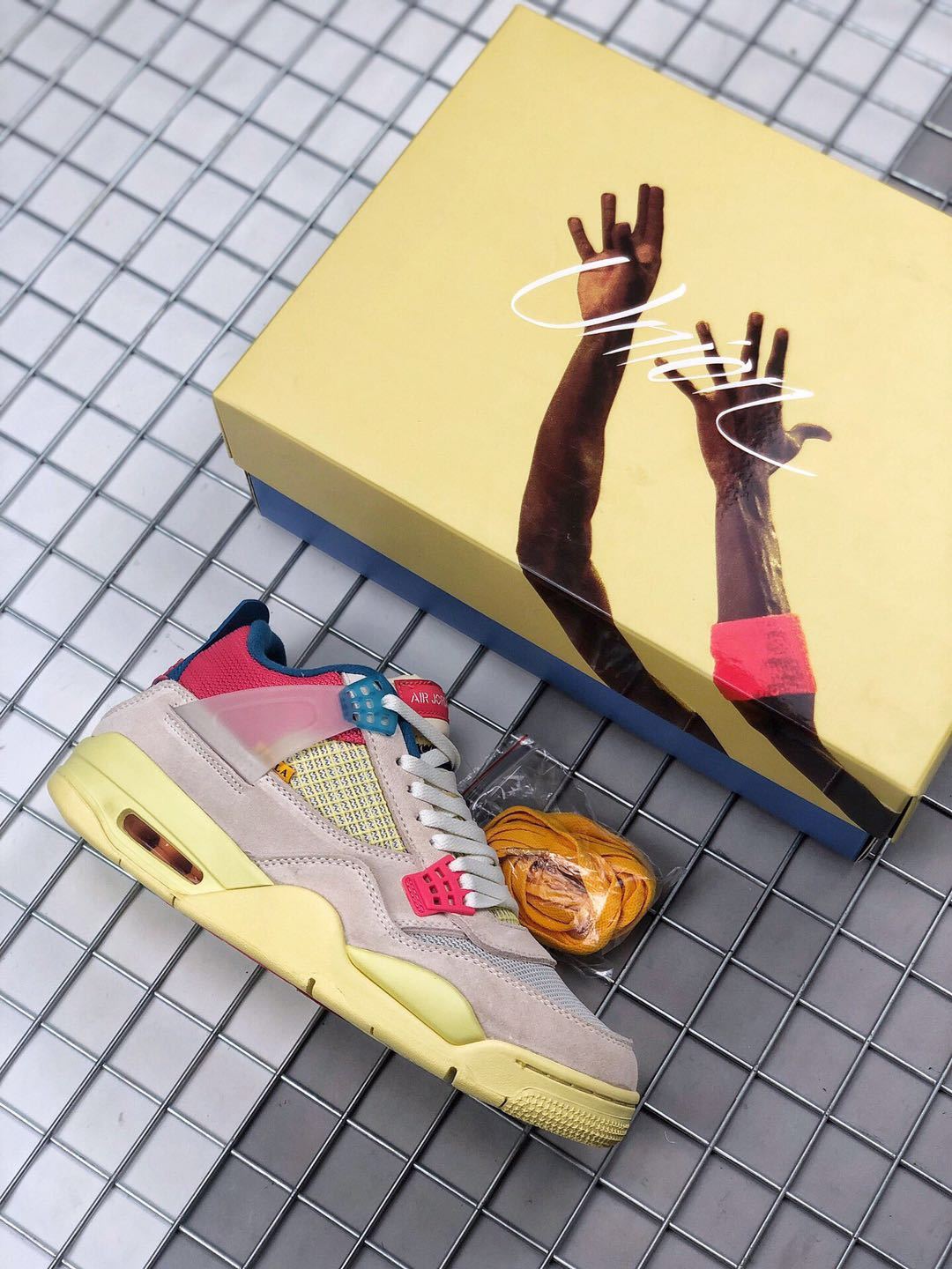Union x Air Jordan 4 Sneakers in Pink Beige Navy Yellow - product image from the listing.