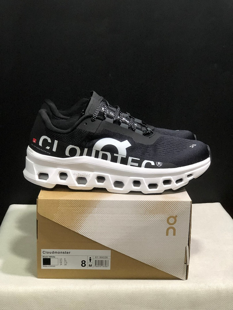 On Cloudmonster Running Sneakers in Black and White - product image from the listing.