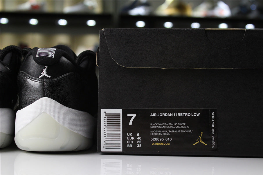 Jordan 11 Retro Low Barons Sneakers in Black White - product image from the listing.