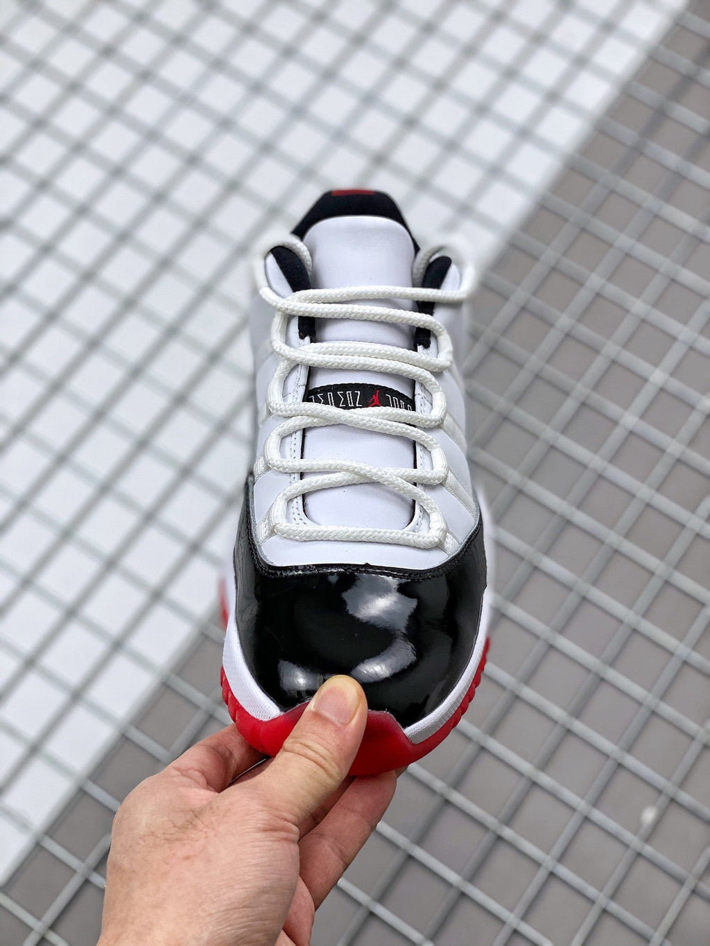 Air Jordan 11 Win Like '82 Sneakers in White Black Red - product image from the listing.