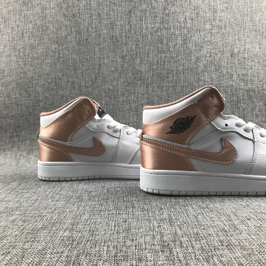 Women's Jordan 1 Mid Rose Gold Silk Sneakers 555112-190 - product image from the listing.