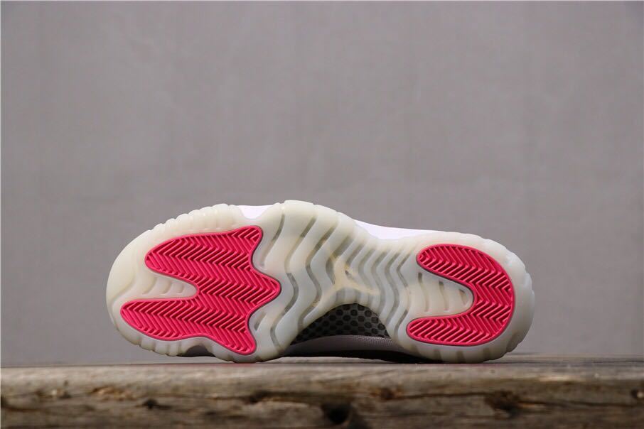 Women's Air Jordan 11 Retro Low Pink Snakeskin Sneakers - product image from the listing.