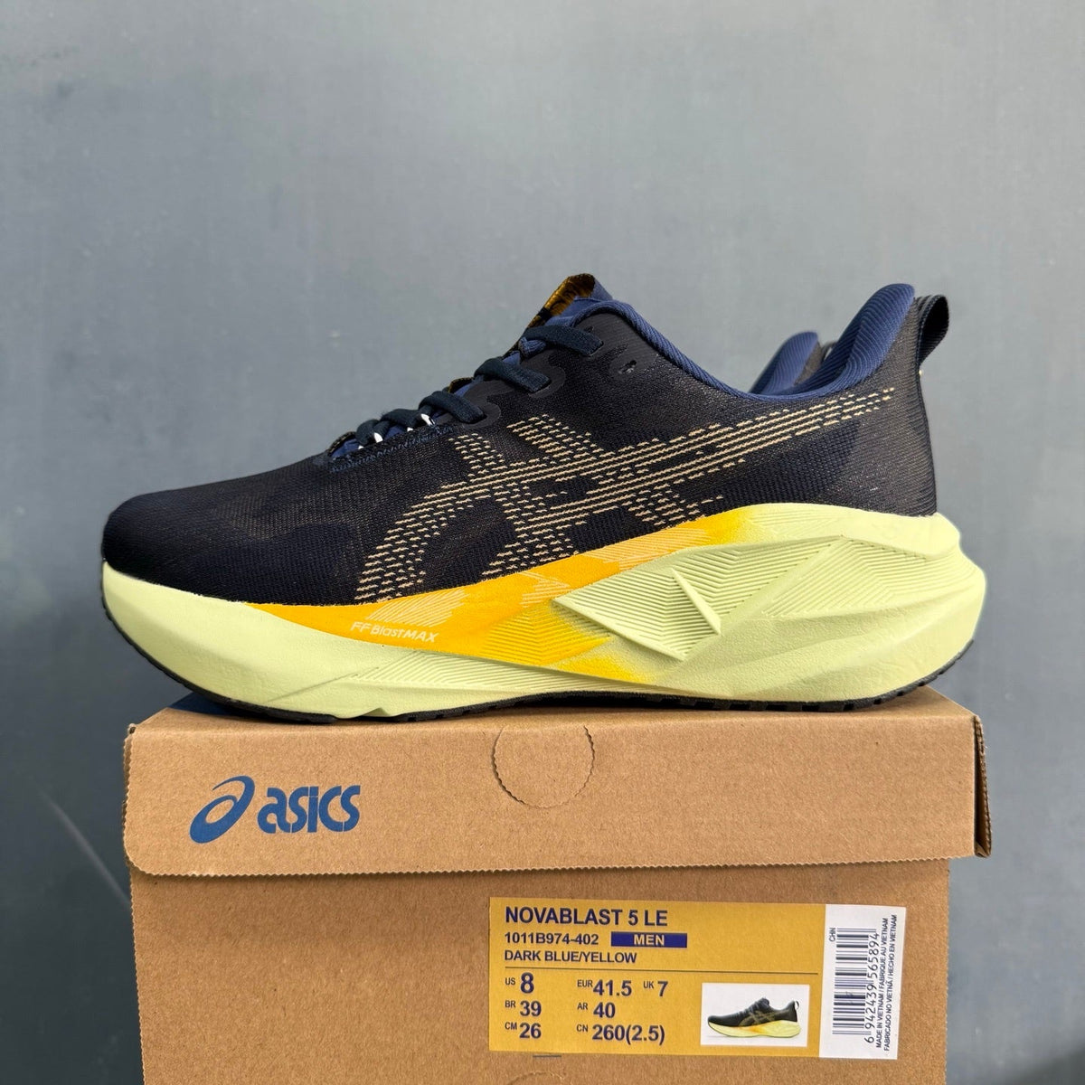 ASICS Novablast 5 LE Running Shoes in Dark Blue Yellow - product image from the listing.