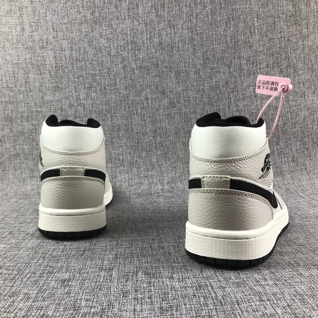 Air Jordan 1 Mid High-Top Sneakers in Grey and Black - product image from the listing.